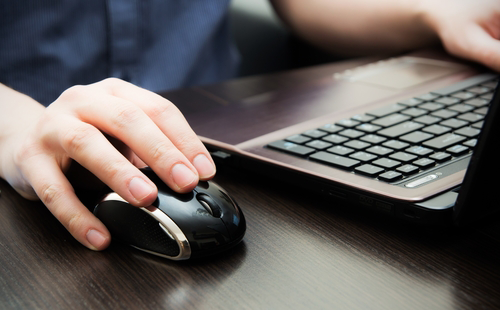 Computer Basics, woman working on a laptop using a mouse